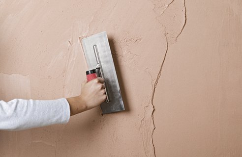 Plastering trowel on wall